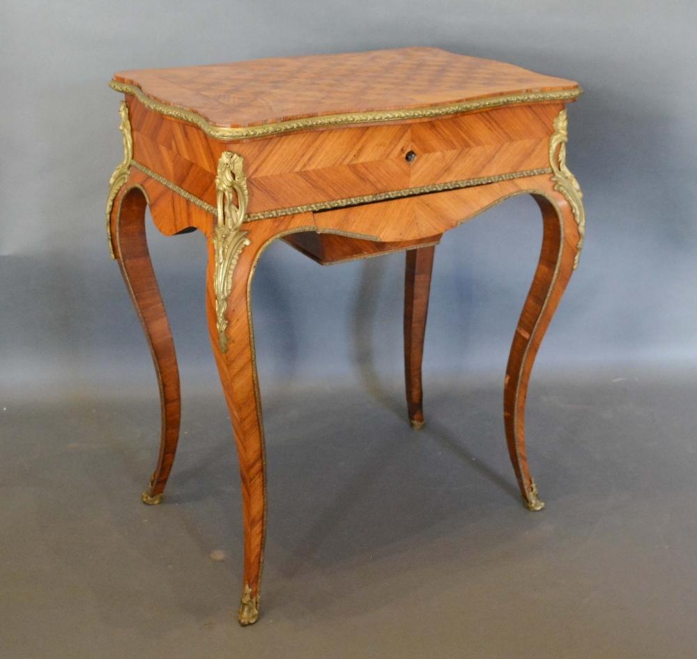 A French Kingwood and Gilt Metal Mounted Work Table, the serpentine parquetry inlaid hinged top