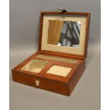 A Leather Jewellery Box, the hinged cover enclosing a fitted interior