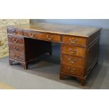 A Mahogany Twin Pedestal Desk, the tooled leather inset top above nine drawers with brass handles,