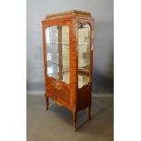 A French Kingwood Gilt Metal Mounted and Marquetry Inlaid Vitrine, the brass galleried top above a