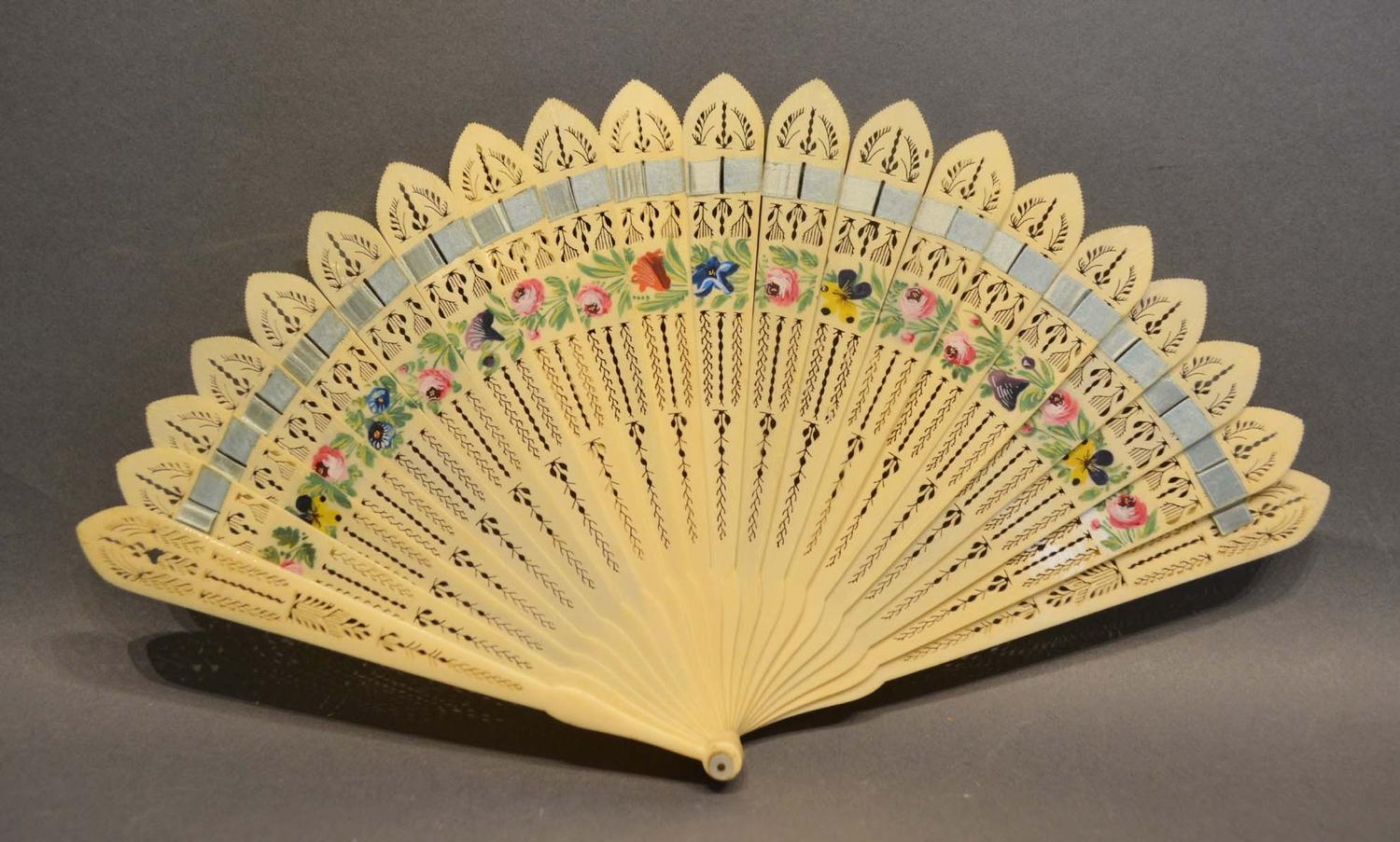 An Early 19th Century Carved Ivory Brise Fan with finely pierced decoration and hand painted with