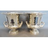 A Pair of Silver Plated Two Handled Wine Coolers with silver plated liners and circular pedestal
