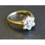 An 18 Carat Gold Diamond Cluster Ring set with seven diamonds, claw set