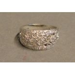 A 9 Carat White Gold Diamond Encrusted Band Ring of pierced form