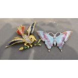 An Enamel and Paste Set Brooch in the form of a bird, together with another similar brooch in the