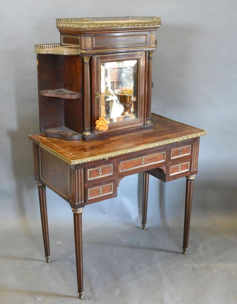 A 19th Century French Bonheur du Jour, the marble topped and brass galleried super structure with