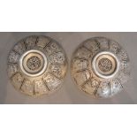 A Pair of Chinese White Metal Dishes decorated in relief with reserves depicting animals, seal marks