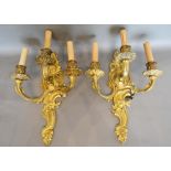A Pair of French Ormolu Three Branch Wall Sconces of shaped scroll form, 44cm long