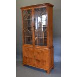 A 20th Century Bow-Fronted Display Cabinet, the moulded cornice above two astragal glazed doors