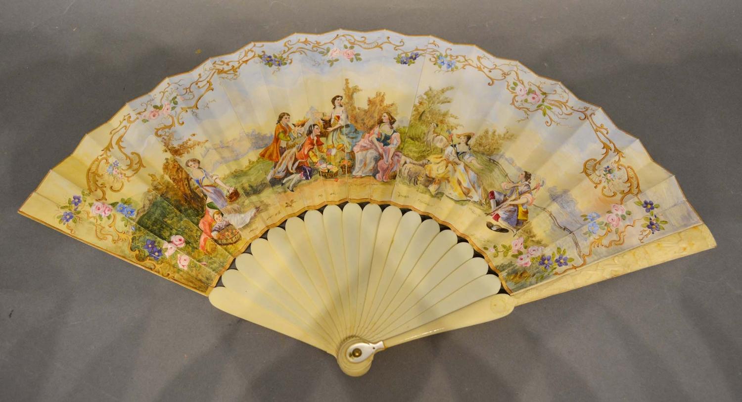 An 18th Century Ivory Fan, hand painted with classical figures within a landscape and within foliate