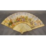 An 18th Century Ivory Fan, hand painted with classical figures within a landscape and within foliate