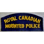 Royal Canadian Mounted Police cloth shoulder title, yellow on blue. A nice patch