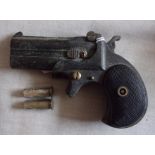 Remington Derringer plug fire pistol, with original brass inserts.