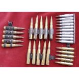 A collection of belted bullets and a stripper clip, Two MG34/42 belted rounds, SA80 stripper clip,