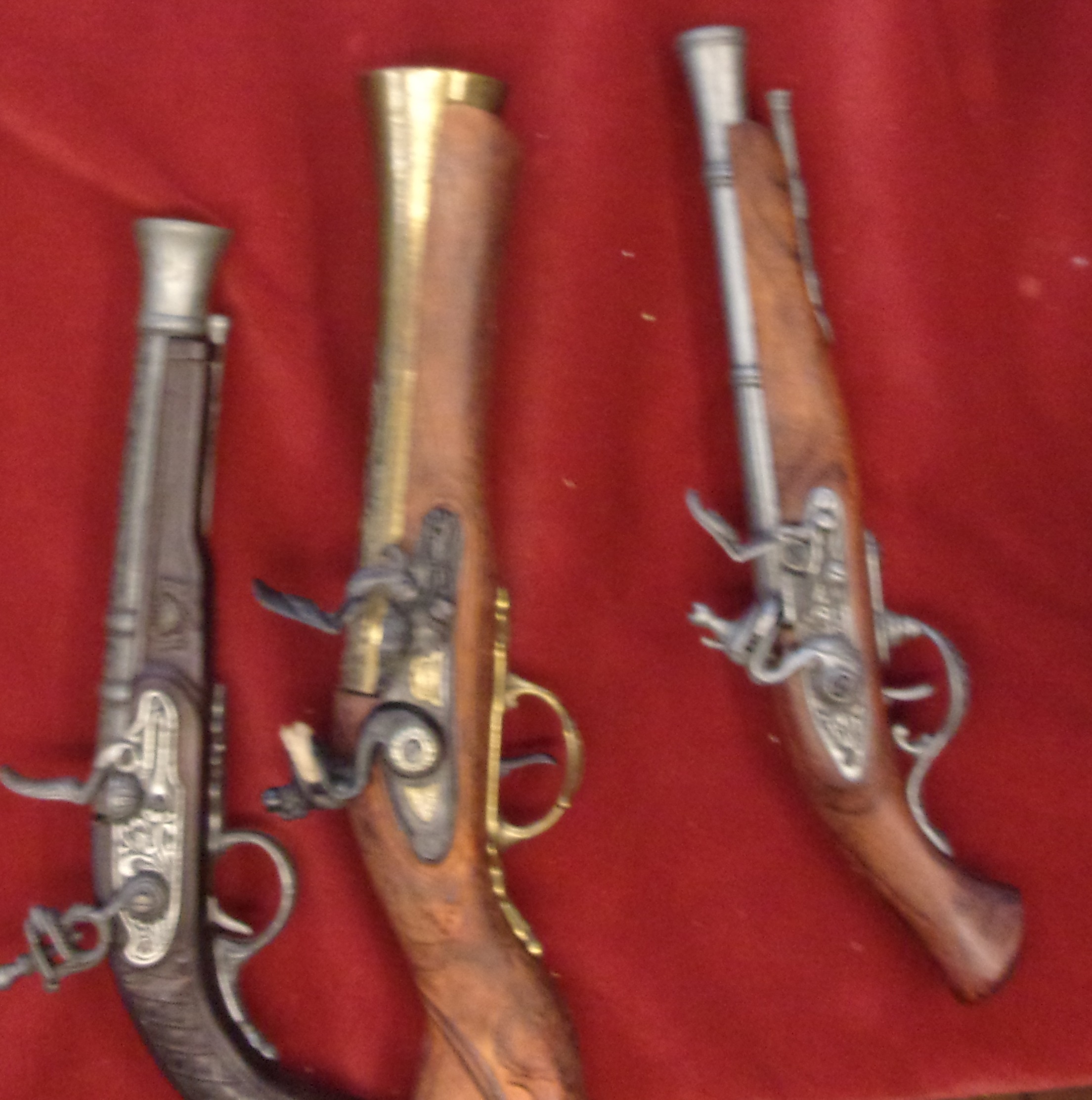 Muskets (3) replica display pieces, a Blunderbuss and two pistols.