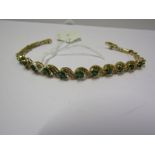 18ct YELLOW GOLD EMERALD & DIAMOND BRACELET, 11 well matched oval cut emeralds seperated by