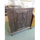 FLEMISH CABINET, a carved oak single door straight front cabinet, decorated with foliate designs,