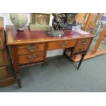 EDWARDIAN DESK, Edwardian walnut 5 drawer kneehole desk, tapering turned legs with castors and