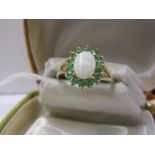9ct YELLOW GOLD OPAL & EMERALD CLUSTER RING, central oval cut opal surrounded by brillinat cut