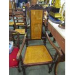 CAROLEAN-DESIGN ARMCHAIR, cane panelled back carved oak open armchair