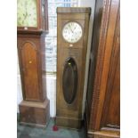 ART DECO LONGCASE CLOCK, oak cased clock with oval bevelled glass pendulum window and satin finish