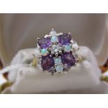 18ct OPAL, AMETHYST & DIAMOND CLUSTER RING, central brilliant cut diamond surrounded by opal and