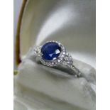 18ct WHITE GOLD SAPPHIRE & DIAMOND CLUSTER RING, central sapphire approx 7.9mm in 4 claw setting,