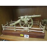 MILITARY, a brass model cannon on wooden plinth, 12" width