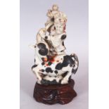 A GOOD QUALITY CHINESE CARVED SOAPSTONE GROUP, of an immortal grappling with a one-horned mythical