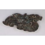 A CHINESE CARVED JADE-LIKE HARDSTONE MODEL OF A PHOENIX, in an archaic style, 3.8in wide & 2.1in