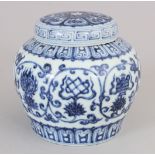 A CHINESE MING STYLE BLUE & WHITE PORCELAIN JAR & COVER, decorated with scrolling formal lotus and
