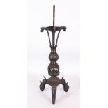 A LARGE CHINESE MING DYNASTY BRONZE TRIPOD CANDLESTICK, supported on Buddhistic lion-head feet,