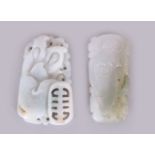 TWO CHINESE PALE CELADON JADE PENDANTS, each 1.8in high. (2)