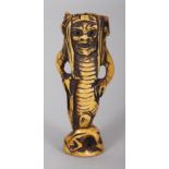 A SIGNED JAPANESE MEIJI PERIOD STAINED IVORY NETSUKE OF AN ONI MERMAN, the base with an engraved