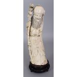 AN EARLY 20TH CENTURY CHINESE CARVED IVORY FIGURE OF SHOU LAO, together with a fixed wood stand, the