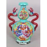 AN EARLY 20TH CENTURY CHINESE FAMILLE ROSE TURQUOISE GROUND DOUBLE GOURD MOULDED PORCELAIN DRAGON
