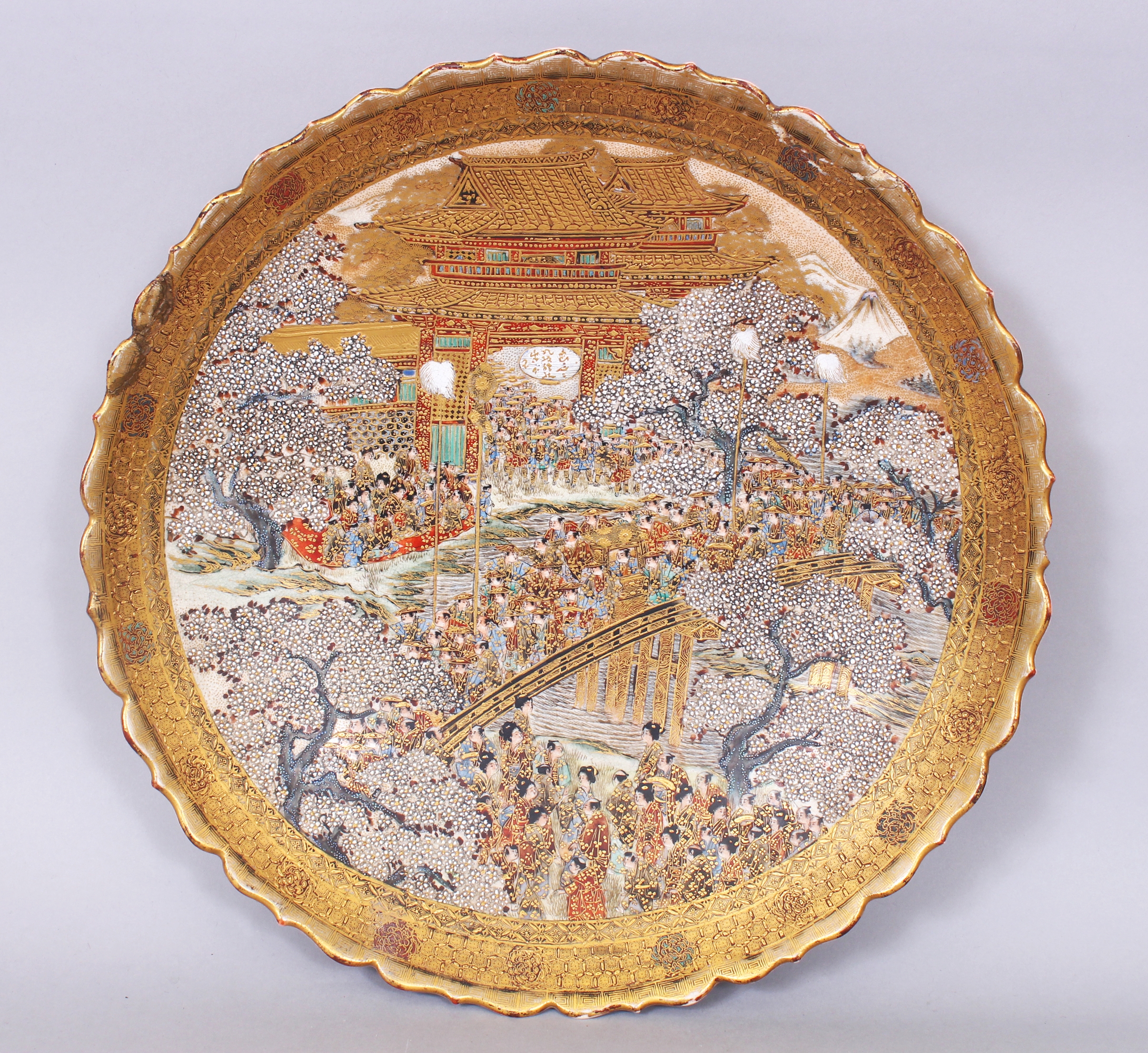 AN UNUSUAL JAPANESE MEIJI PERIOD SATSUMA EARTHENWARE DISH, painted with a detailed scene of a