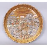 AN UNUSUAL JAPANESE MEIJI PERIOD SATSUMA EARTHENWARE DISH, painted with a detailed scene of a