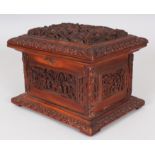 A 19TH CENTURY CHINESE CANTON CARVED WOOD RECTANGULAR CASKET, the hinged cover and sides decorated