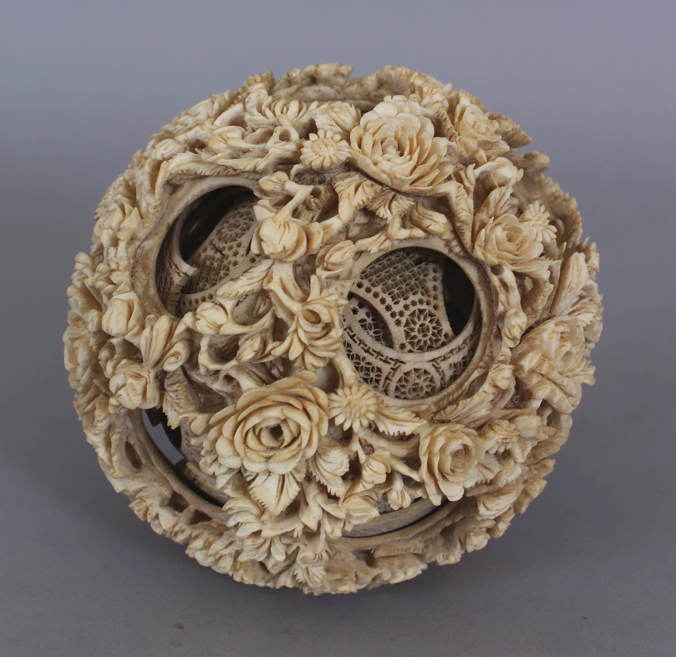 A LARGE 19TH CENTURY CHINESE CARVED IVORY CONCENTRIC BALL, weighing approx. 377gm, the outer