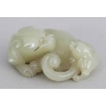 A 19TH/20TH CENTURY CHINESE CELADON JADE MODEL OF A LION DOG & ITS CUB, 2in wide.