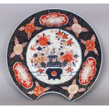 A JAPANESE IMARI PORCELAIN BARBER'S BOWL, decorated to its centre with a jardiniere of flowers, 11.