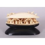 AN EARLY 20TH CENTURY CHINESE IVORY MODEL OF THE CLAM'S DREAM, together with a fitted wood stand,