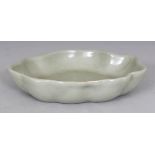 AN UNUSUAL CHINESE CELADON GLAZED PORCELAIN BRUSHWASHER, with a wavy rim, the base unglazed, 5.1in x