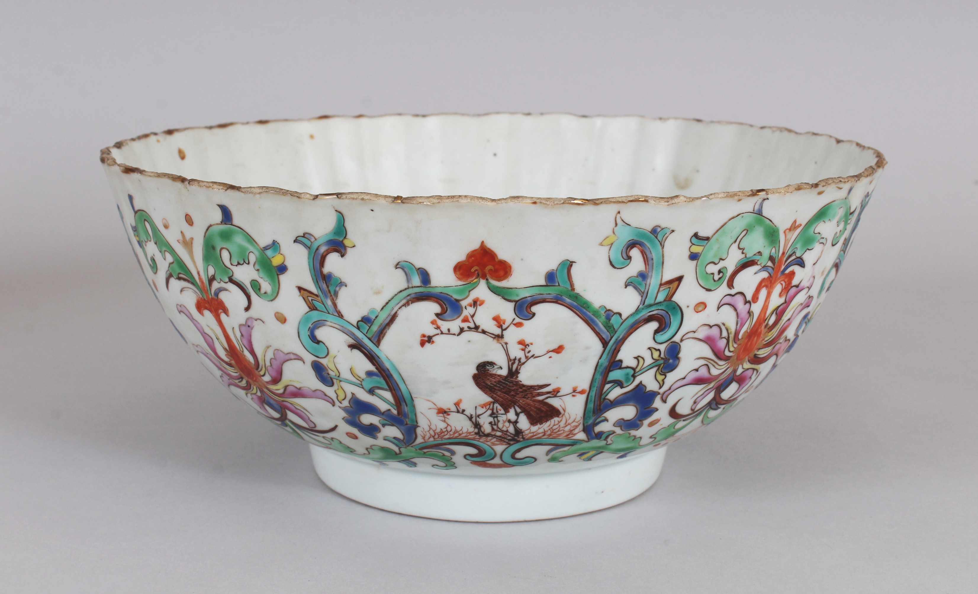 AN UNUSUAL EARLY 18TH CENTURY CHINESE FAMILLE ROSE FLUTED PORCELAIN BOWL, painted with formal