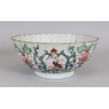 AN UNUSUAL EARLY 18TH CENTURY CHINESE FAMILLE ROSE FLUTED PORCELAIN BOWL, painted with formal