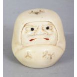 A SIGNED JAPANESE MEIJI PERIOD IVORY NETSUKE OF A DARUMA DOLL, with frowning expression, his mouth