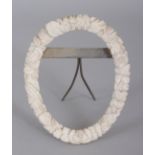 ANOTHER SMALL 19TH CENTURY CHINESE CANTON IVORY OVAL PICTURE FRAME, the rim carved with