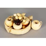 A GOOD JAPANESE MEIJI PERIOD SECTIONAL IVORY GROUP OF A WOOD GRAINED TRAY OF FRUITS, 6in wide.