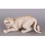 A FINE QUALITY JAPANESE MEIJI PERIOD IVORY OKIMONO OF A SNARLING LION, its fur naturalistically